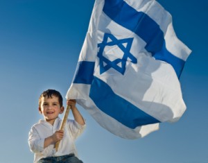 young boy holding the Israeli flag